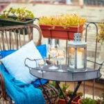 Balkon mit Tisch, Stuhl, Kerzen und Pflanzen